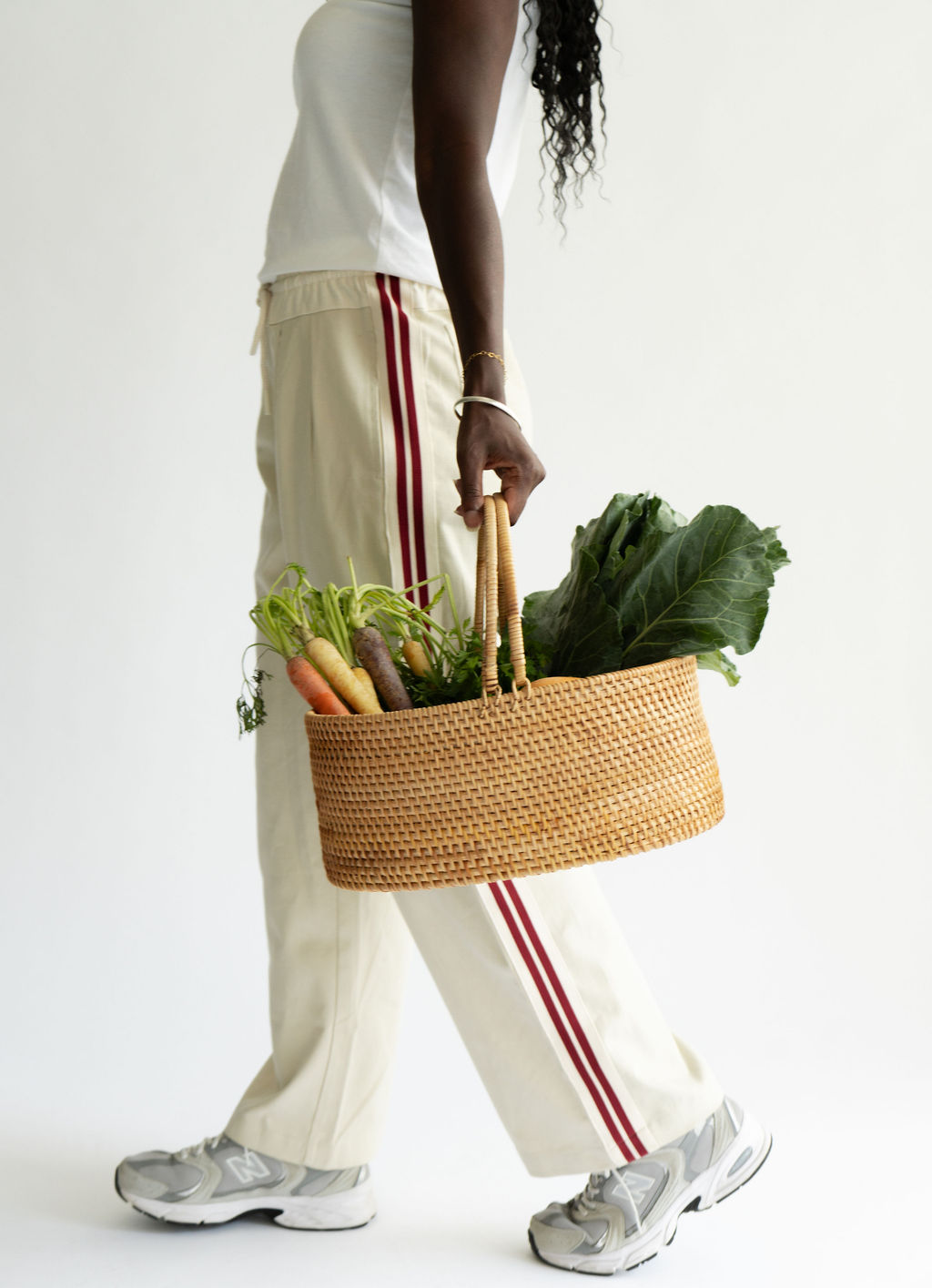 Miriam wood walking across with a basket full of fresh produce